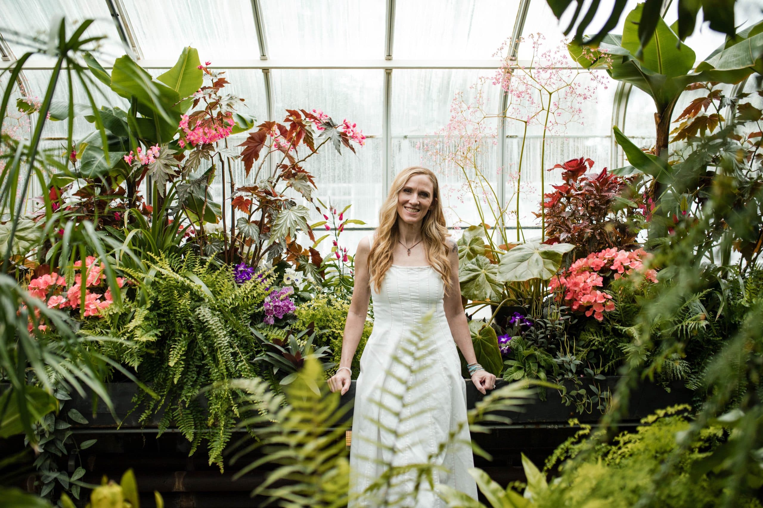 Kimberlie Carlson in a greenhouse