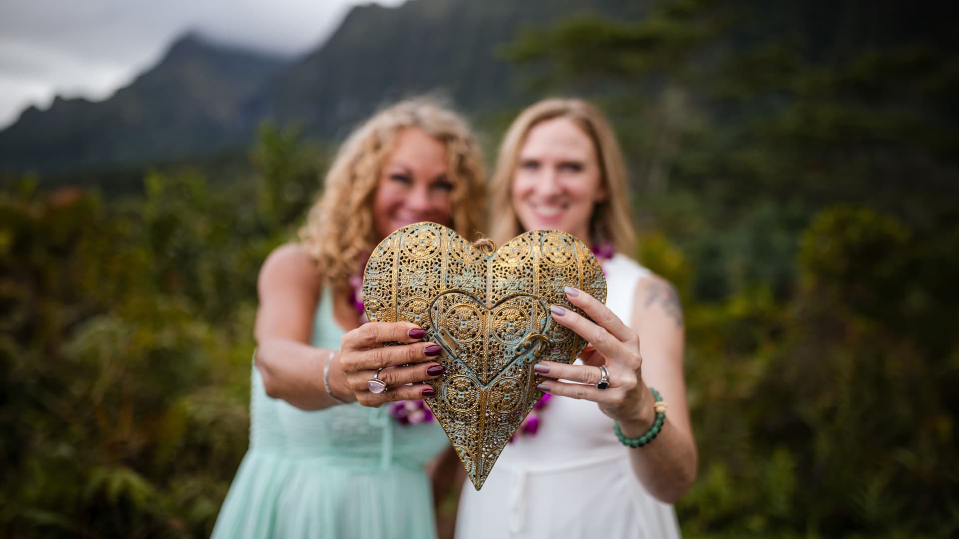Elysia and Kimberlie holding a golden heart